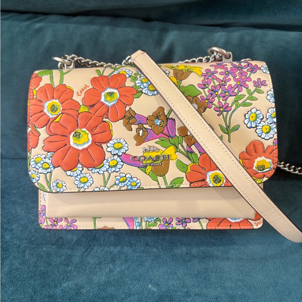 Coach Klare Crossbody Bag with a floral print and turnlock closure